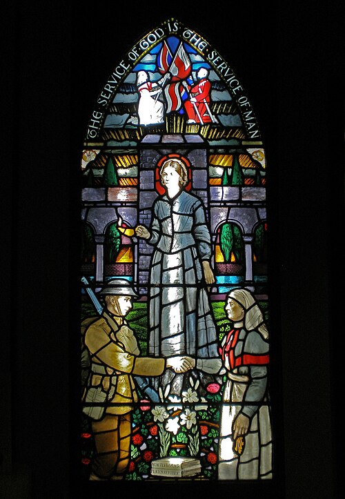 Stained glass window depicting Florence Nightingale with the inscription “The service of God is the service of man.”